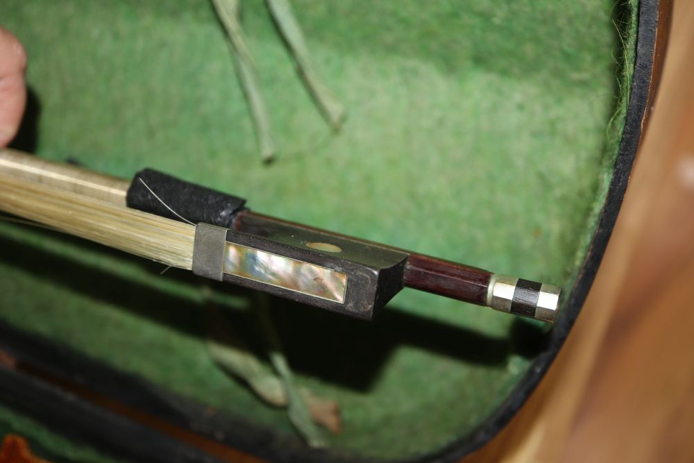 A late 19th century European violin with inlaid decoration, cased with bow, Joseph Guanaris label to interior of violin